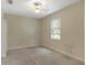 Cozy bedroom with a ceiling fan, neutral walls, carpet, and a bright window at 1269 Long Cove Loop # 1269, Davenport, FL 33896