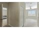Carpeted bedroom offering ample natural light with a ceiling fan and a view into the en-suite bathroom at 1269 Long Cove Loop # 1269, Davenport, FL 33896
