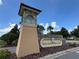 Inviting stone community sign for The Champions Club under a bright blue sky at 1269 Long Cove Loop # 1269, Davenport, FL 33896