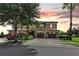 Beautiful two-story home with a well-manicured lawn, mature trees, and brick paved driveway at 1269 Long Cove Loop # 1269, Davenport, FL 33896