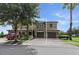 Beautiful two-story home with a well-manicured lawn, mature trees, and brick paved driveway at 1269 Long Cove Loop # 1269, Davenport, FL 33896