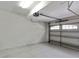 Clean, empty garage with white walls, white ceiling, and white garage door at 1269 Long Cove Loop # 1269, Davenport, FL 33896