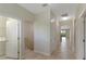 Bright hallway with tiled floors leading to rooms with arched doorways and a view to the balcony at 1269 Long Cove Loop # 1269, Davenport, FL 33896