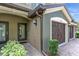Home exterior featuring brick paved entryway, dark brown garage doors, and a glass front door at 1269 Long Cove Loop # 1269, Davenport, FL 33896