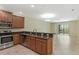 Stylish kitchen with stainless steel appliances, granite countertops, and open access to the living area at 1269 Long Cove Loop # 1269, Davenport, FL 33896