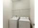 Functional laundry room with a washer, dryer, and wire shelving for storage at 1269 Long Cove Loop # 1269, Davenport, FL 33896