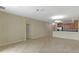Open-concept living room featuring tile floors that flow into the adjacent kitchen with warm wood cabinetry at 1269 Long Cove Loop # 1269, Davenport, FL 33896