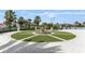 Beautifully designed community pool area with fountain, turf circle, and palm trees at 1269 Long Cove Loop # 1269, Davenport, FL 33896