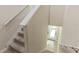 Bright entryway from the top of the stairs featuring carpeted steps and white walls at 1269 Long Cove Loop # 1269, Davenport, FL 33896