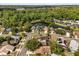 Aerial view of community featuring mature trees, various homes, and a peaceful pond at 1346 Palo Alto Ct, Winter Springs, FL 32708