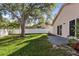 Landscaped backyard featuring a well-maintained lawn, and a beautiful mature shade tree at 1346 Palo Alto Ct, Winter Springs, FL 32708