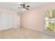 Bright bedroom featuring tile flooring, a ceiling fan, window with blinds, and closet at 1346 Palo Alto Ct, Winter Springs, FL 32708
