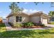 Exterior view of home with landscaped garden bed and attached two car garage at 1346 Palo Alto Ct, Winter Springs, FL 32708