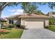 Charming single-story home features a two-car garage, well-maintained lawn, and beautiful landscaping at 1346 Palo Alto Ct, Winter Springs, FL 32708