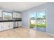 Well-lit kitchen with tiled flooring, stainless steel appliances, and sliding door to the outdoors at 1346 Palo Alto Ct, Winter Springs, FL 32708
