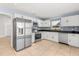 Modern kitchen features stainless steel appliances, granite countertops, and white cabinetry at 1346 Palo Alto Ct, Winter Springs, FL 32708