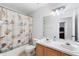 Bathroom with dual sinks, a seashell-themed shower curtain, and ample lighting at 1400 Holly Glen Run, Apopka, FL 32703