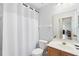 Clean bathroom with a white shower curtain, toilet, and vanity with sink at 1400 Holly Glen Run, Apopka, FL 32703