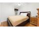 Bedroom featuring a bed with a neutral comforter, side tables, and a window at 1400 Holly Glen Run, Apopka, FL 32703
