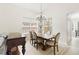 Dining room featuring a wooden table, chandelier lighting, and neutral decor at 1400 Holly Glen Run, Apopka, FL 32703