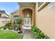 Charming front entrance with double doors, decorative plants, and manicured landscaping at 1400 Holly Glen Run, Apopka, FL 32703