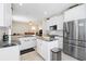 Bright kitchen featuring white cabinets, stainless steel appliances, and a center island at 1400 Holly Glen Run, Apopka, FL 32703