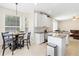 Modern kitchen with white cabinetry, granite countertops, and stainless steel appliances at 1400 Holly Glen Run, Apopka, FL 32703