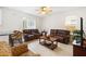 Cozy living room with tile flooring, a ceiling fan, and comfortable leather seating at 1400 Holly Glen Run, Apopka, FL 32703