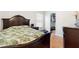 Bedroom with dark wood furniture, a large bed, and a walk-in closet at 1400 Holly Glen Run, Apopka, FL 32703