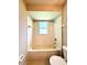 This bathroom has tiled shower/tub, tiled floors, and a window for natural light at 14715 Buckingham Gate Ct, Orlando, FL 32828
