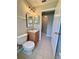 Bathroom featuring tile floor, vanity, decorative lighting, and open door to hallway at 14715 Buckingham Gate Ct, Orlando, FL 32828