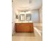 Bathroom with double sinks, framed mirrors and a large tub at 14715 Buckingham Gate Ct, Orlando, FL 32828