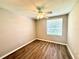 Neutral bedroom features a ceiling fan, window, and wood-look floors at 14715 Buckingham Gate Ct, Orlando, FL 32828