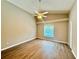 Bright bedroom features new flooring, a ceiling fan and a large window to let the sunshine in at 14715 Buckingham Gate Ct, Orlando, FL 32828