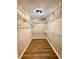 Walk-in closet with wood-style flooring and wire shelves at 14715 Buckingham Gate Ct, Orlando, FL 32828