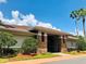 Exterior view of the fitness center, with stone accents, landscaping, and a covered entrance at 14715 Buckingham Gate Ct, Orlando, FL 32828