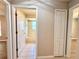 Hallway view leading to bathroom featuring tile floors, and access to another room at 14715 Buckingham Gate Ct, Orlando, FL 32828