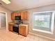 Updated kitchen featuring a window seat, stainless appliances, and wood cabinets at 14715 Buckingham Gate Ct, Orlando, FL 32828