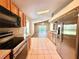 Kitchen showcasing tile floors, modern stainless steel appliances and easy access to the living space at 14715 Buckingham Gate Ct, Orlando, FL 32828