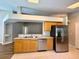 Bright kitchen with stainless steel refrigerator and dishwasher, tile floors, and convenient breakfast bar at 14715 Buckingham Gate Ct, Orlando, FL 32828