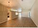 Bright, open-concept living space with wood flooring and modern light fixtures at 14715 Buckingham Gate Ct, Orlando, FL 32828