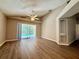 Open living area with wood floors, sliding glass door, and a view of the pool at 14715 Buckingham Gate Ct, Orlando, FL 32828