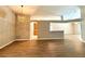 Bright, open-concept living space with wood flooring and modern light fixtures at 14715 Buckingham Gate Ct, Orlando, FL 32828