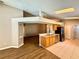 Open-concept kitchen and living area featuring tile and wood floors, skylight, and stainless steel appliances at 14715 Buckingham Gate Ct, Orlando, FL 32828
