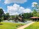 Community playground featuring multiple slides, swings, and climbing structures plus picnic tables and landscaping at 14715 Buckingham Gate Ct, Orlando, FL 32828