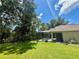Screened-in pool on a sunny day, surrounded by a lush green lawn and mature trees providing privacy at 14715 Buckingham Gate Ct, Orlando, FL 32828