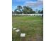 Large, grassy backyard enclosed by a white fence, perfect for outdoor activities and relaxation at 1635 Wynford Cir, Tavares, FL 32778