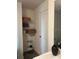 Bathroom storage with shelving, a decorative black vase, and easy access to personal care items at 1635 Wynford Cir, Tavares, FL 32778