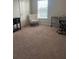 Bright bedroom area with neutral carpet and a comfortable chair, creating an inviting workspace at 1635 Wynford Cir, Tavares, FL 32778