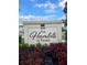 Elegant community sign 'The Hamlets of Tavares' amidst lush landscaping, creating a welcoming entrance at 1635 Wynford Cir, Tavares, FL 32778